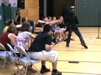 High School Stage Hypnotist Bruce James demonstrating hypnosis with his project graduation safe hypnotist show.